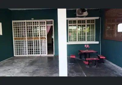 a room with a table and a door and a table and chairs at Jalinan Qaseh Homestay in Seri Manjung