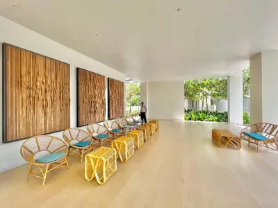a room with a row of chairs and tables at By The Sea Deluxe Condo @ Batu Ferringhi Penang in Batu Ferringhi
