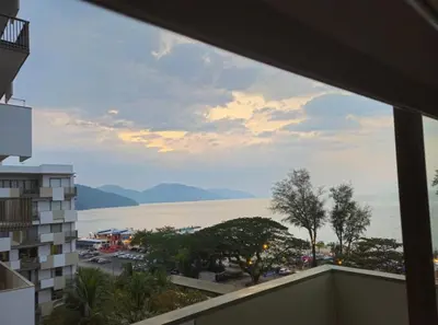 a view of the water from the balcony of a building at By The Sea Deluxe Condo @ Batu Ferringhi Penang in Batu Ferringhi
