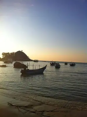 a group of boats in the water on a beach at By The Sea Deluxe Condo @ Batu Ferringhi Penang in Batu Ferringhi