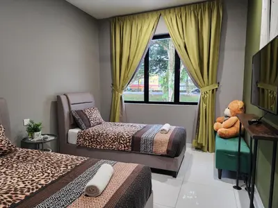a bedroom with two beds and a window at Ipoh Eden Pool Villa Suites in Ipoh