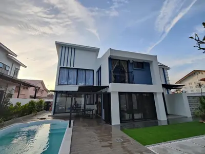 a house with a swimming pool in front of it at Ipoh Eden Pool Villa Suites in Ipoh