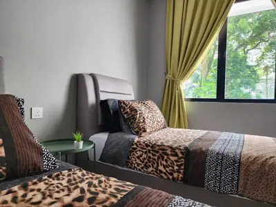 a room with two beds and a window at Ipoh Eden Pool Villa Suites in Ipoh