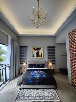 a bedroom with a large bed and a chandelier at Ipoh Eden Pool Villa Suites in Ipoh