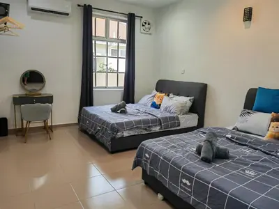a bedroom with two beds with stuffed animals on them at Padang Serai Room Stay Share Bathroom in Padang Serai
