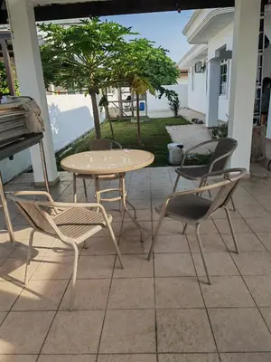 a table and chairs on a patio with a table at Padang Serai Room Stay Share Bathroom in Padang Serai
