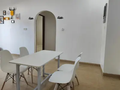 a white table and white chairs in a room at Padang Serai Roomstay Family Suite Share Bathroom804 in Padang Serai