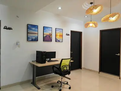 an office with a desk with a computer and a chair at Padang Serai Roomstay Family Suite Share Bathroom804 in Padang Serai