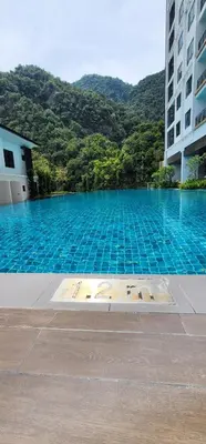 a large swimming pool in front of a building at Doma House Onsen at Sunway Onsen, Tambun in Ipoh
