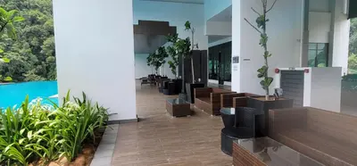 a lobby of a building with a pool and plants at Doma House Onsen at Sunway Onsen, Tambun in Ipoh