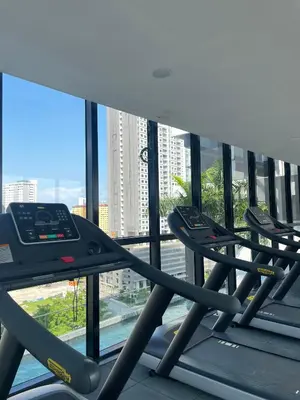 a row of treadmills in a gym with a large window at 2 Carpark 3R2B 10 Pax City View Condominium 23A in Jelutong