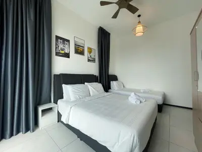 a bedroom with two beds with white sheets at 2 Carpark 3R2B 10 Pax City View Condominium 23A in Jelutong