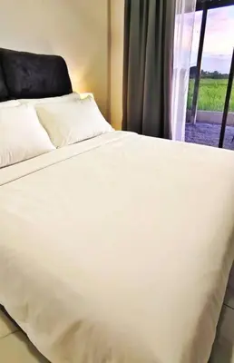 a white bed in a room with a window at Paddy Villea with 5 Bedrooms Penang in Permatang Pauh