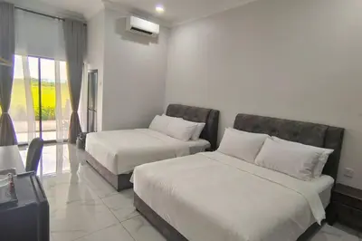 a hotel room with two beds and a window at Paddy Villea with 5 Bedrooms Penang in Permatang Pauh
