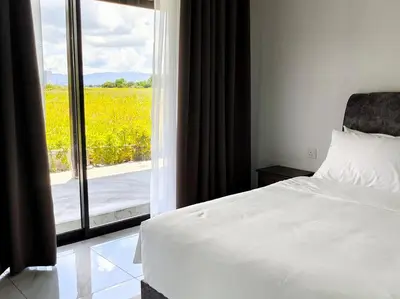 a bedroom with a bed and a window with a view at Paddy Villea with 5 Bedrooms Penang in Permatang Pauh