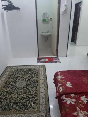 a bathroom with a mirror and a rug on the floor at DIAMOND HOMESTAY in Kuala Kangsar