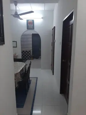 a hallway of a house with a table and chairs at DIAMOND HOMESTAY in Kuala Kangsar