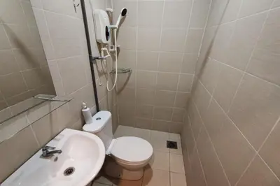 a small bathroom with a toilet and a sink at Maleeq Hotel Meru Ipoh in Ipoh