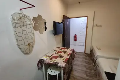 a small room with a table and a door at Maleeq Hotel Meru Ipoh in Ipoh