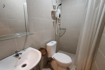 a bathroom with a toilet and a sink and a shower at Maleeq Hotel Meru Ipoh in Ipoh