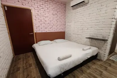 a small room with a bed with two towels on it at Maleeq Hotel Meru Ipoh in Ipoh