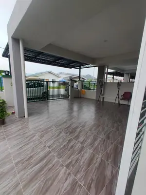 an empty patio with a table and a chair at Swedish Style Homestay in Teluk Intan