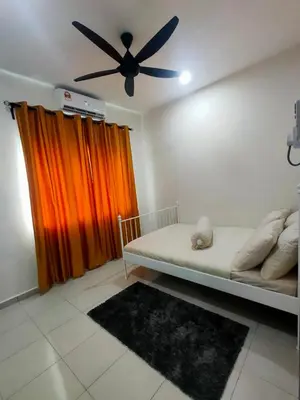 a bedroom with a bed with a ceiling fan at Swedish Style Homestay in Teluk Intan