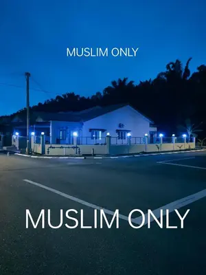 a night view of a house with the words muslin only at Swedish Style Homestay in Teluk Intan