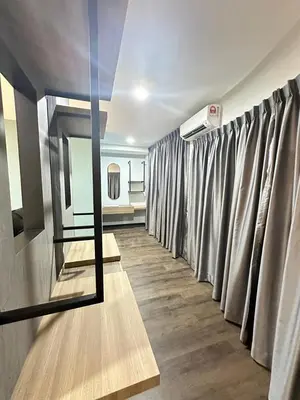 a dressing room with curtains and a mirror at EpochHotel in Taiping