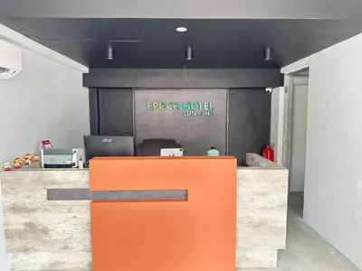 an orange bench in front of a reception desk at EpochHotel in Taiping