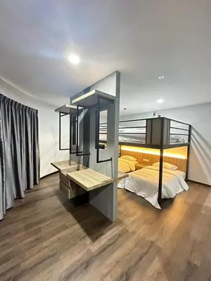 a bedroom with a bed and a desk in it at EpochHotel in Taiping
