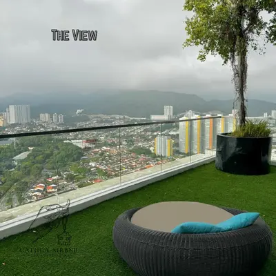 a large tire sitting on the grass on a balcony at Urban Suites Studio #SelfCheck-In #PrivateSpace in Jelutong