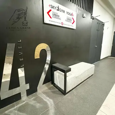 a bench in front of a wall with a sign at Urban Suites Studio #SelfCheck-In #PrivateSpace in Jelutong