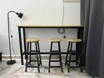 a table and two stools under a counter at Near 7ELEVE KFC 10pax 3BR Hutan Melintang by willz in Hutan Melintang