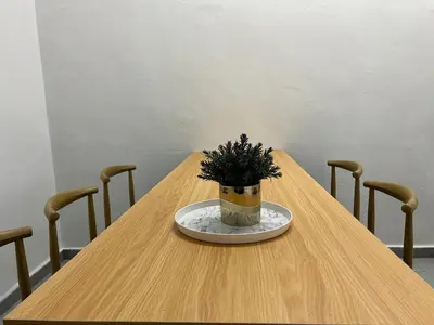 a wooden table with a potted plant on a plate at Near 7ELEVE KFC 10pax 3BR Hutan Melintang by willz in Hutan Melintang