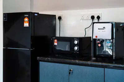 a microwave sitting on a counter in a kitchen at Ben Cozy Executive Suite 3BR The Horizon Ipoh in Ipoh
