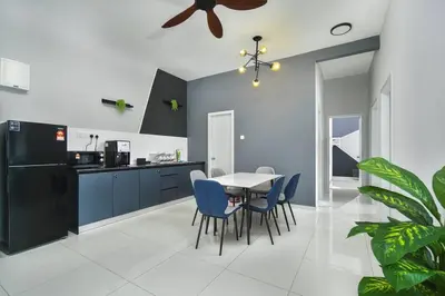 a kitchen with a dining table and blue chairs at Ben Cozy Executive Suite 3BR The Horizon Ipoh in Ipoh