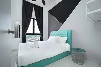 a bedroom with a bed with a blue headboard and a window at Ben Cozy Executive Suite 3BR The Horizon Ipoh in Ipoh