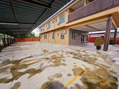 an empty parking lot in front of a building at The Blue Guest House, WiFi, Free Parking, Aulong in Taiping