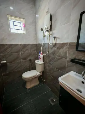 a bathroom with a toilet and a sink at The Blue Guest House, WiFi, Free Parking, Aulong in Taiping