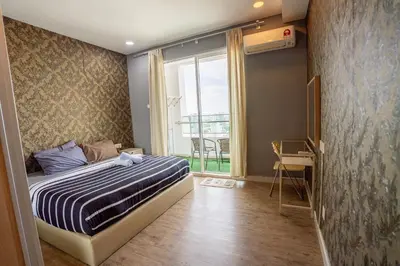 a bedroom with a bed and a large window at Georgetown Seaview MansionOne @Penang in George Town