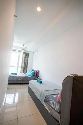 a living room with two beds and a couch at Georgetown Seaview MansionOne @Penang in George Town