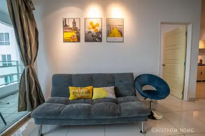 a living room with a couch and a blue chair at Georgetown Seaview MansionOne @Penang in George Town