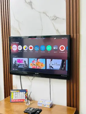 a flat screen tv sitting on top of a table at Home in Simpang Ampat in Simpang Ampat