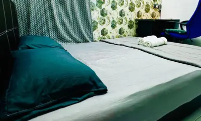 a bed with two towels on top of it at Home in Simpang Ampat in Simpang Ampat