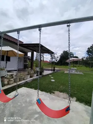 an empty swing set in a yard with at Z&S Gerik Hillview Homestay in Gerik
