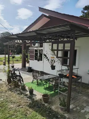 a pavilion with a picnic table and chairs in a yard at Z&S Gerik Hillview Homestay in Gerik