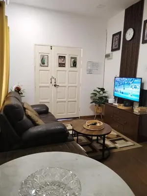 a living room with a couch and a tv at Z&S Gerik Hillview Homestay in Gerik