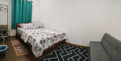a living room with a bed and a couch at Z&S Gerik Hillview Homestay in Gerik