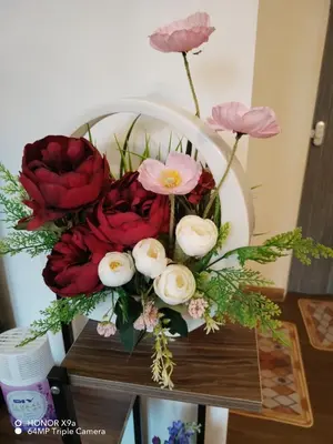 a bouquet of red and white flowers on a table at Z&S Gerik Hillview Homestay in Gerik